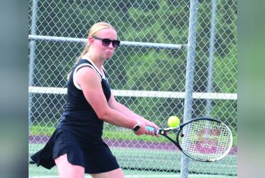  Allison Retzlaff hits the ball back to her opponent.